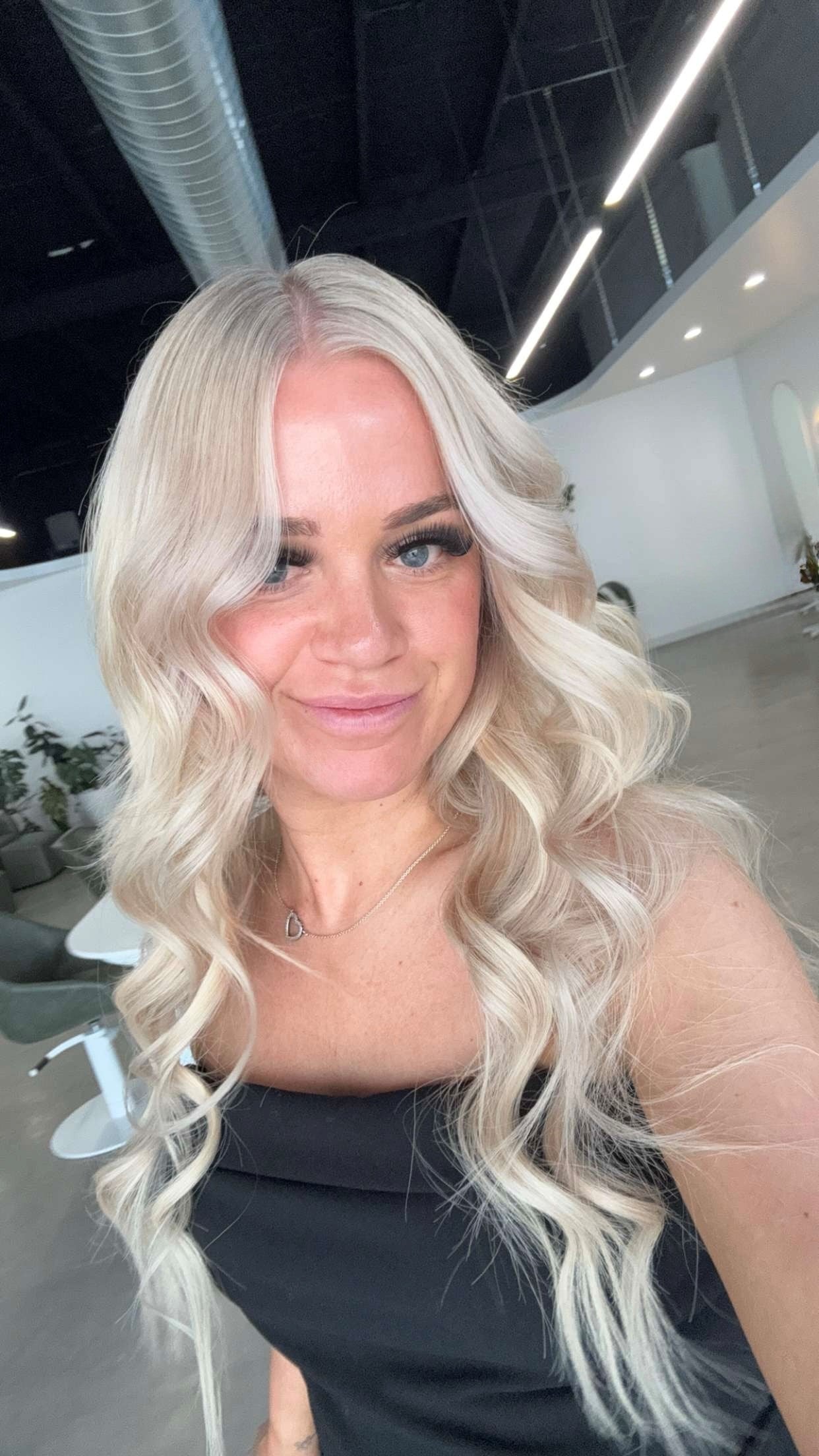 Woman with long blonde hair in a modern indoor setting